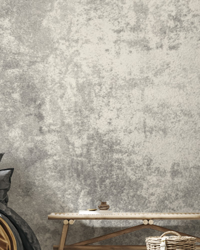 Stone Patina  wallpaper, featuring a textured stone design.  A bedroom interior with  wallpaper on the wall, showcasing the subtle nuances of the pattern.