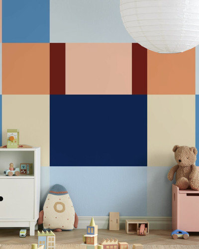 Fototapet cu design geometric în nuanțe de albastru și piersică în camera unui copil.
