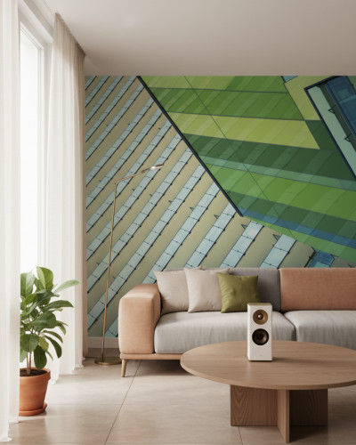 Living modern decorat cu fototapet Patterned Line Study - personalizat, ilustrând un design arhitectural cu linii geometrice în nuanțe de verde, gri și bej pe un perete accent, lângă o canapea bej și plantă de interior.