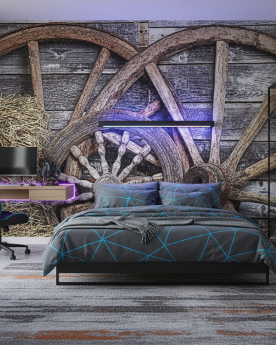Fototapet Rustic Cartwheel Patina - personalizat, într-un restaurant modern cu scaune verzi, având un perete decorat cu roți de căruță vechi și baloturi de fân, creând o atmosferă caldă și primitoare.