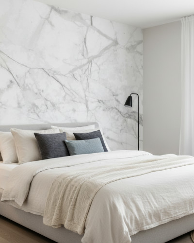 Dormitor modern luminos cu perete accent decorat cu fototapet Opulent Marble Veins cu vene de marmură alb-gri. Pat matrimonial gri, noptieră din lemn și lampă de masă.